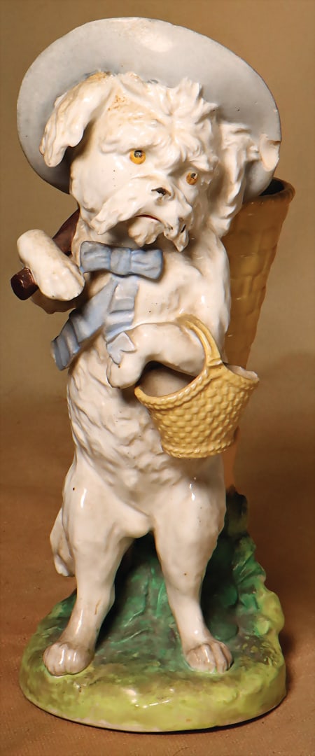 Glazed porcelain, dog with pannier and basket, h: 23 cm, chips and small chip to the rim of the hat,: Glazed porcelain, dog with pannier and basket, h: 23 cm, chips and small chip to the rim of the hat, "Spielzeugmuseum Graz" German Description Glasiertes Porzellan, Hund mit Kiepe u. Korb, H: 23 cm, A