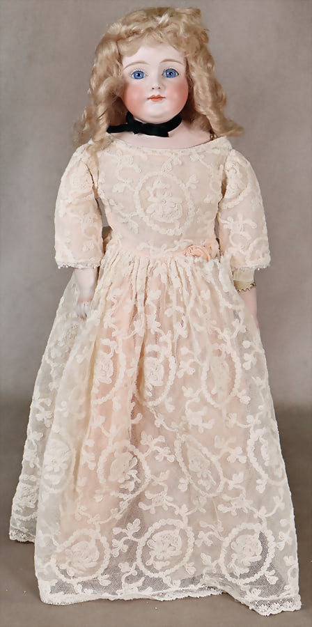 Porcelain shoulder headed doll, gem. 6, blue fix inset glass eyes, slit mouth, chin dimples, leather: Porcelain shoulder headed doll, gem. 6, blue fix inset glass eyes, slit mouth, chin dimples, leather body, porcelain forearms. glass eyes, closed mouth, dimpled chin, leather body, porcelain forearms