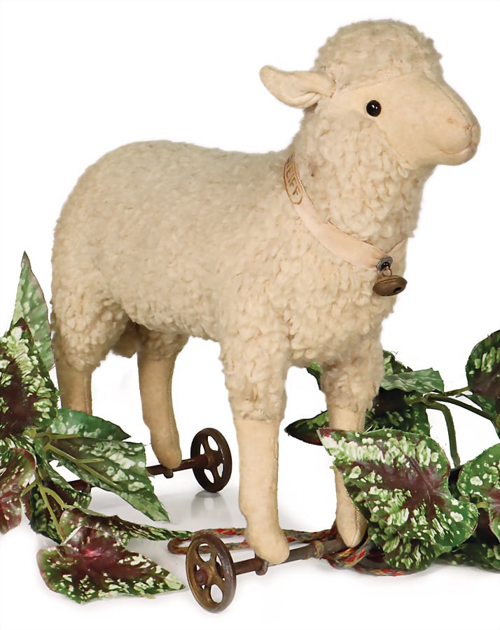 STEIFF lamb on cast spoked wheels, made of real lambskin, felt face, ears and legs, small shoe (1 of 4)