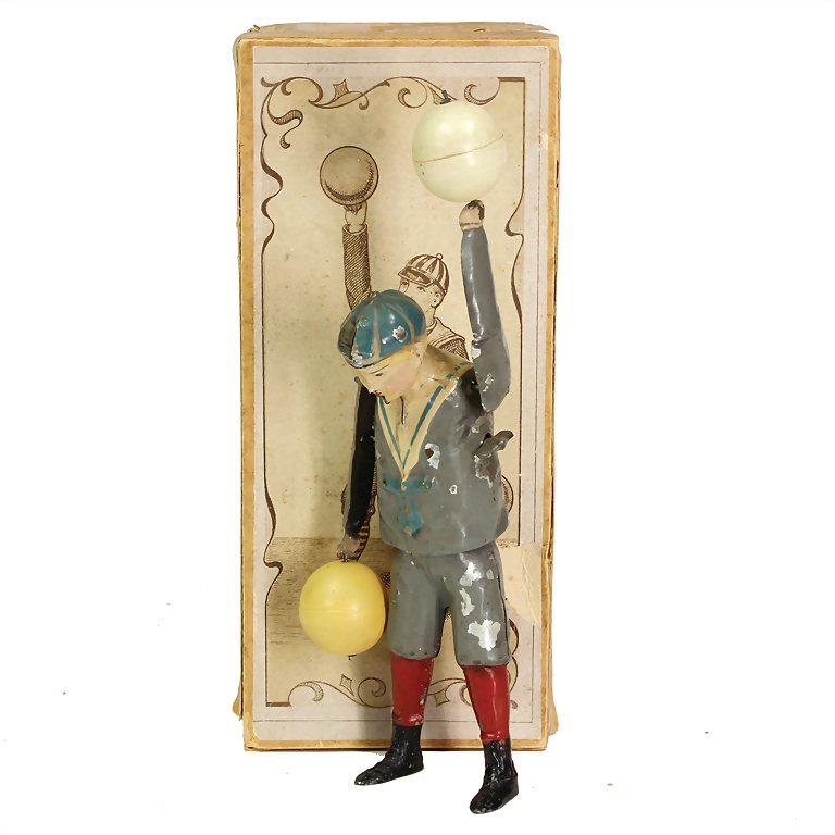 Bing, Gebr. boy with 2 balls, handpainted sheet metal,: Bing, Gebr. boy with 2 balls, handpainted sheet metal, around 1905, 250 x 95 x 75 mm, 80 x 260 x 110 mm, good condition, with loss of color, intact, with original box German Description Bing, Gebr. Kn