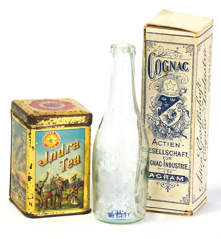 2 pieces shop accessories, tea box, Indra Tea: 2 pieces shop accessories, tea box, Indra Tea lithographed sheet metal, heigth : 5 cm, cognac bottle, in original box German Description 2 Teile Kaufladenzubehör, Teedose, Indra Tea, Blech, lithogr.,