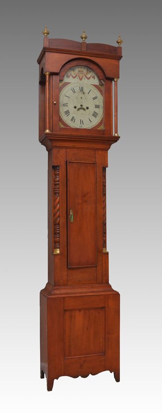 EARLY 19TH CENTURY CHERRY CONCORD TALL CASE CLOCK: EARLY 19TH CENTURY CHERRY CONCORD TALL CASE CLOCK: Early 1800's cherry case, bonnet with brass spires, full columns with brass accents, waist with carved 1/4 column stiles, base with carved skirt. Pai