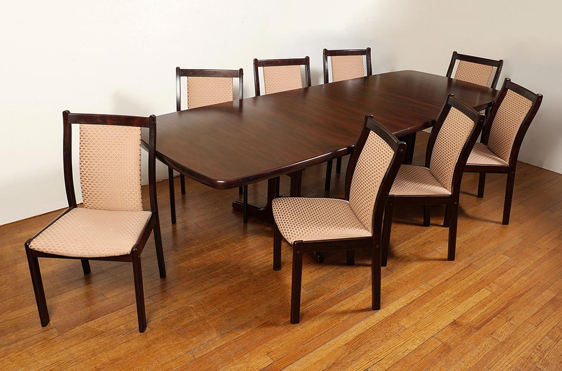 DANISH MODERN ROSEWOOD VENEER DINING SET: DANISH MODERN ROSEWOOD VENEER DINING SET: To include a rosewood veneer dining table marked ''AM 85, Made in Denmark'', 28 3/4'' h. x 65'' x 39'', the 2 leaves 19 3/4'' each. Sold with 8 Boltinge Danis