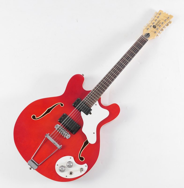 CHERRY MOSRITE CELEBRITY 3 SEMI-HOLLOW BODY GUITAR: MOSRITE CELEBRITY 3 CHERRY 12 STRING GUITAR: Cherry body, serial number W0108, circa 1966-1968, 12 string, 3 bolt back, overall measures 42'' x 16''. Sold with a hard case, 45'' h. x 18'' x 5 1/4''.