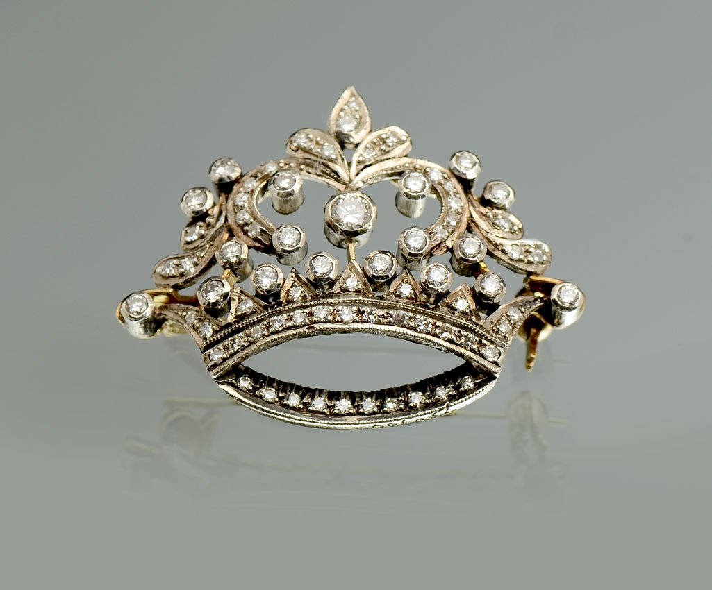 MAJESTIC 18K & STERLING SILVER DIAMOND BROOCH CROW: MAJESTIC 18K & STERLING SILVER DIAMOND BROOCH CROWN: .75CTW in circular brilliant cut diamonds are set to form a stately crown creating this brooch. Measures 1.25'' W x 1''H.