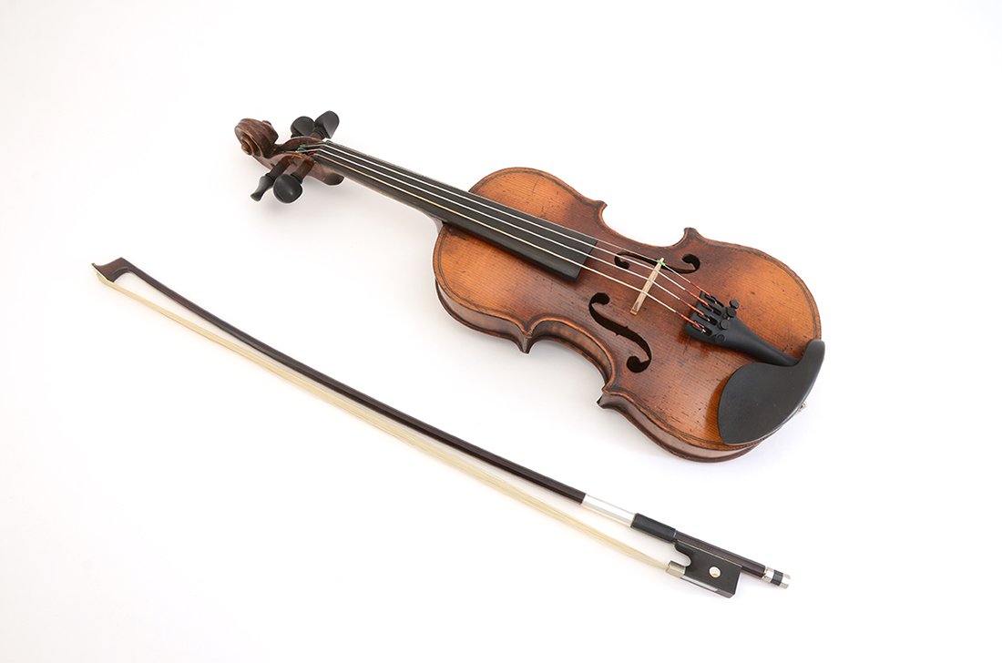 GERMAN 1/8 SIZE VIOLIN & BOW: GERMAN 1/8 SIZE VIOLIN & BOW: Spurious Stradivarius label inside, 9 3/4" single piece back, overall 17" long. H. Luger 20" bow, approx. 43.3 grams with hair. Sold with a soft case, 24 1/4" x 8 1/2" x 