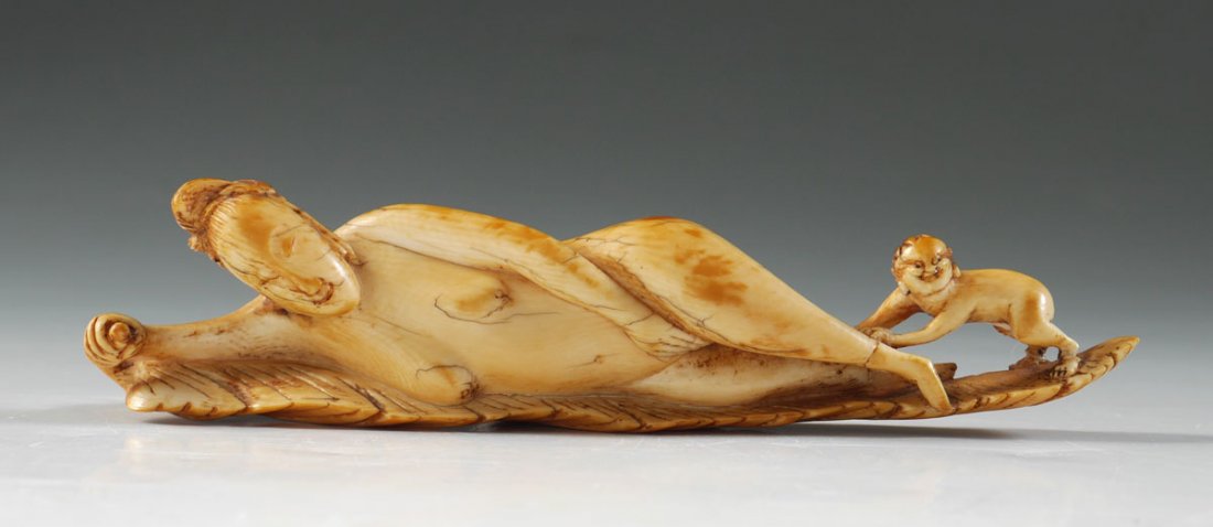 ANTIQUE CARVED IVORY DOCTORS MODEL: ANTIQUE CARVED IVORY DOCTORS MODEL: Certified antique ivory, circa 1850's, figure of a reclining nude woman in leaf with a child at her feet. Overall measures 1 1/2" h. x 6" 1". Sold with copies of ap