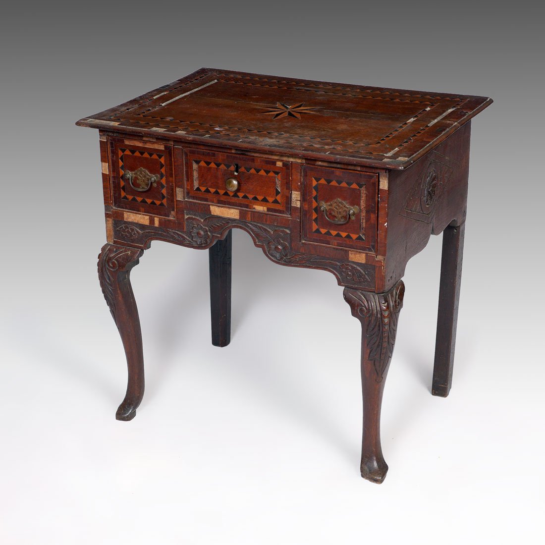 EARLY PARQUETRY INLAID OAK DRESSING TABLE: EARLY PARQUETRY INLAID OAK DRESSING TABLE: Top with inlaid star central medallion, top and the 3 drawer fronts with parquetry inlaid bands. Sides and skirt cared with floral designs, front shaped legs