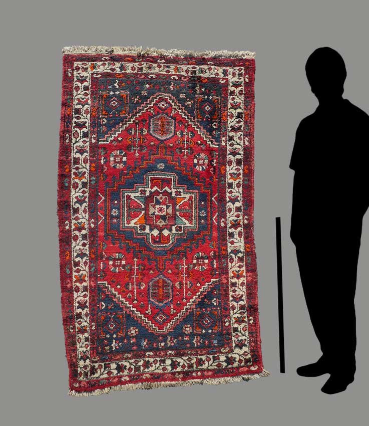 N.W. PERSIAN HAND KNOTTED WOOL RUG, 5' X 6'8": APPROX 25-45 YR OLD N.W. PERSIAN HAND KNOTTED WOOL RUG, 5' X 6'8": This shaggy village rug has a central medallion within a medallion, star within white outlined by blue and rust stepped bands on a re