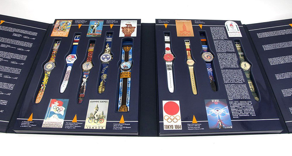 SWATCH HISTORICAL OLYMPIC GAME COLLECTION: SWATCH HISTORICAL OLYMPIC GAME COLLECTION: Commemorating the 1996 Olympic in Atlanta, complete set of 9 Swatch watches in display box, box measures 16 1/2" x 12 1/2" x 2".