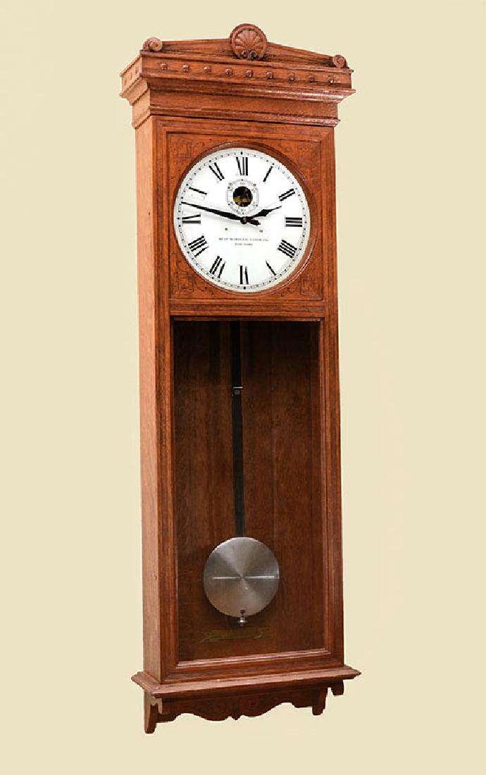 SELF WINDING #9 OAK JEWELERS REGULATOR CLOCK: SELF WINDING #9 OAK JEWELERS REGULATOR CLOCK: #9 oak case by The Self Winding Clock Co., pediment with carved center shell and scroll at either end. Door with round top glass, open lower glass. Marked