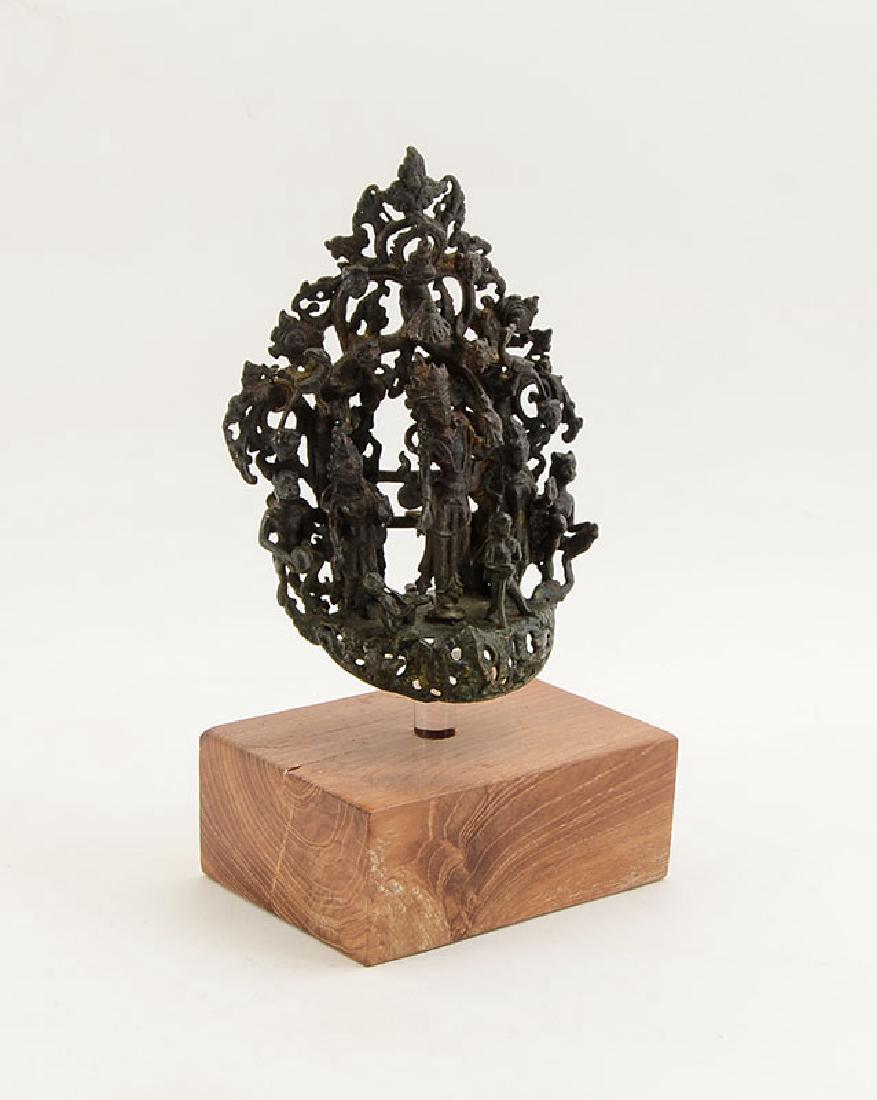 THAI CAST METAL BODHISATTVA FIGURAL GROUP: THAI CAST METAL BODHISATTVA FIGURAL GROUP: Figure of Buddhist deity and attendants, with tree background, measures 6 1/4'' h. x 4 1/2'' x 2''. Sold with a wood and Lucite stand, 3 1/4'' h. x 4 5/8'' x
