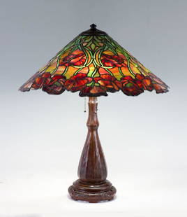 UNIQUE POPPY LEADED GLASS TABLE LAMP: UNIQUE POPPY LEADED GLASS TABLE LAMP: Signed Handel patinated bronze base with ribbed sides and reticulated base, 3 Hubbell socket fixture, measures 24 3/4" h. x 7". Unique Glass "California Poppy" fl