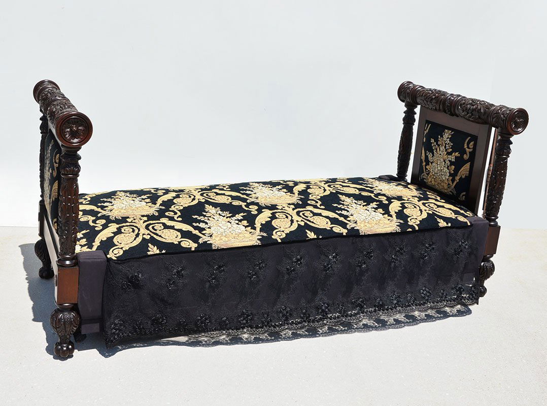 VICTORIAN CARVED WOOD DAY BED: VICTORIAN CARVED WOOD DAY BED: Carved and turned foliate motif headboard and foot board, floral urn motif needlepoint cushion and side panels, lace skirt. Overall measures 36 3/4" h. x 80 1/4" x 33 3/