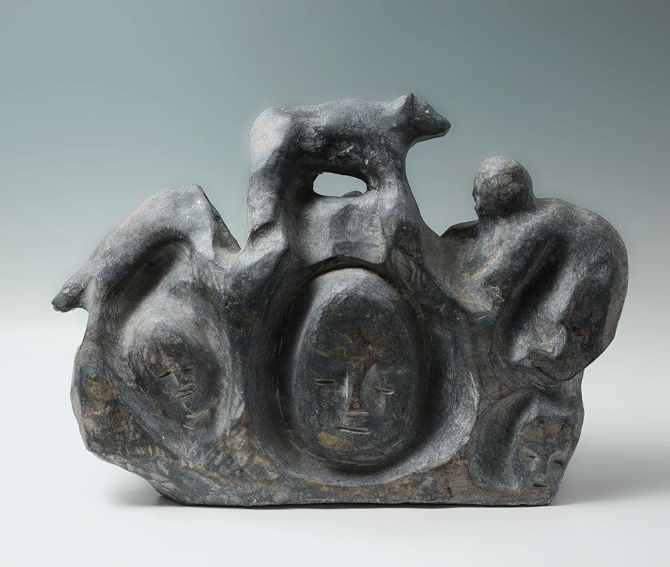 INUIT CARVED STONE FIGURAL GROUP: INUIT CARVED STONE FIGURAL GROUP: Heavy carved stone sculpture, stylized human figures with bears, relief carved faces, no visible signature. Overall measures 15 1/4'' h. x 20 1/2'' x 6 1/2''