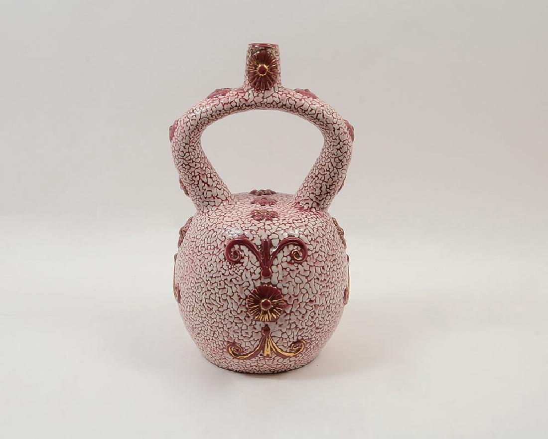 ZSOLNAY SHRIVELED GLAZE VASE / VESSEL: ZSOLNAY SHRIVELED GLAZE VASE / VESSEL: Late 19th century pink coral ''shriveled'' glaze all over and applied decoration. Unique form with singled arched handle with opening at top of handle. Marked on
