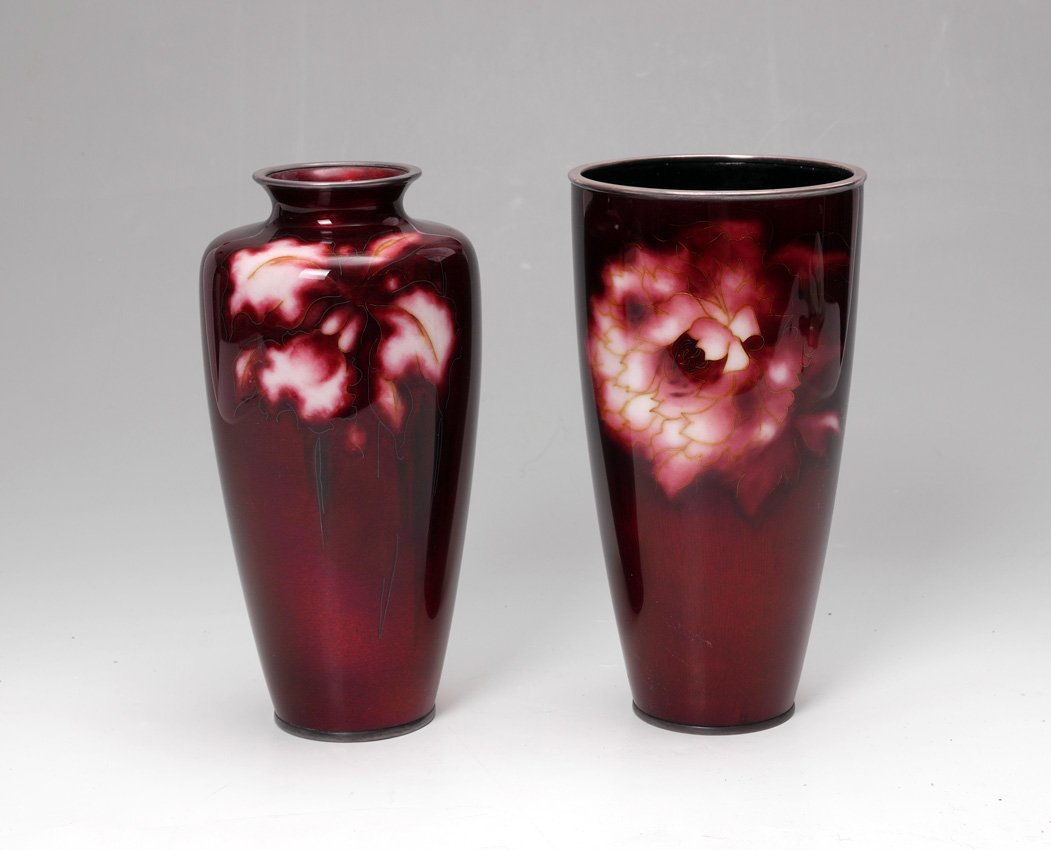 2 JAPANESE ANDO OXBLOOD CLOISONNE VASES: 2 JAPANESE ANDO OXBLOOD CLOISONNE VASES: 2 vases, each with oxblood red ground and white flowers, marked with Ando flower on bases, baluster form measures 9 1/2" h. x 4 1/2", tapered cylinder form mea