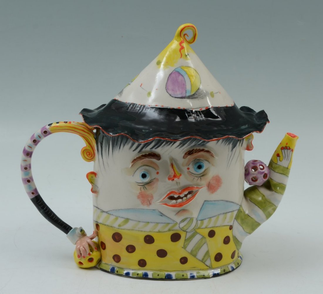 IRINA ZAYTCEVA WHIMSICAL PORCELAIN FIGURAL TEAPOT: IRINA ZAYTCEVA WHIMSICAL PORCELAIN FIGURAL TEAPOT: Part of a 4 part sea set, this represents the son, figural bust of a boy with shaped arm handle, polychrome decoration. Signed with initials on back,