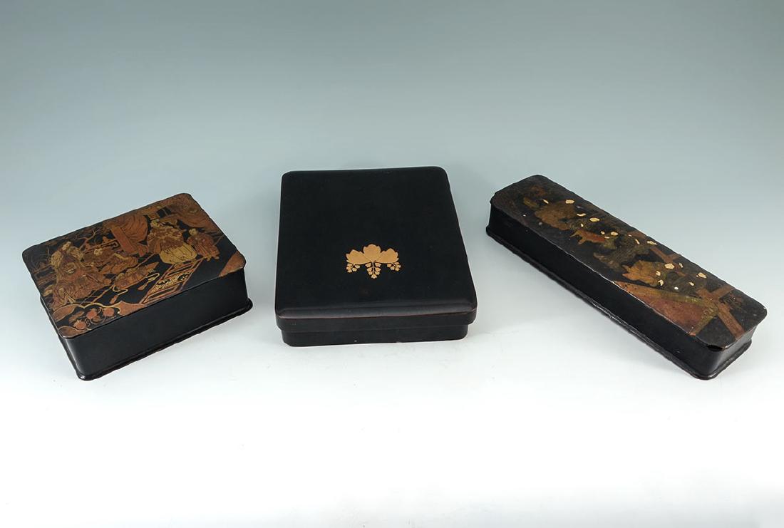 2 CHINOISERIE & OTHER BLACK LACQUER BOXES: 2 CHINOISERIE & OTHER BLACK LACQUER BOXES: 3 pieces total, 2 boxes with chinoiserie decoration to include 1) Pin or glove box with hinged lid, red interior, 2'' h. x 11 1/2'' x 3 1/2''. 2) Dresser box