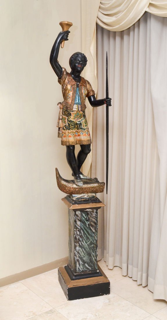 POLYCHROME PAINTED CARVED BLACKAMOOR FIGURE: POLYCHROME PAINTED CARVED BLACKAMOOR FIGURE: Nicely detailed with gilt and polychrome paint decoration blackamoor figure with one arm held upward, the other hand holding a spear. Figure is standing on