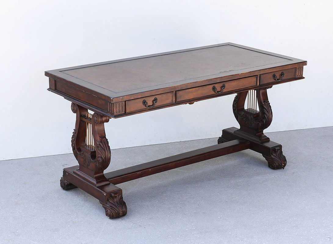 DOUBLE CARVED HARP BASE EXECUTIVE DESK: DOUBLE CARVED HARP BASE EXECUTIVE DESK: Leather inset top over 3 drawers, double carved harp form supports at either end, 30 1/4" h. x 60" x 30".