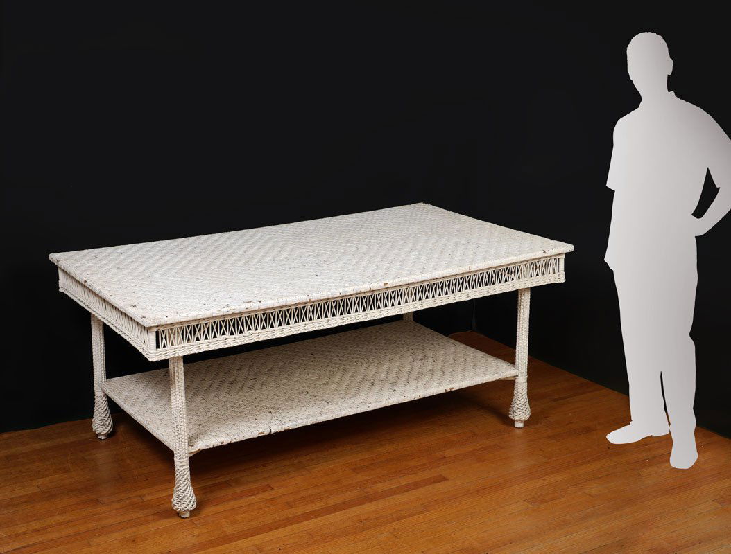 LARGE ANTIQUE WHITE WICKER DINING TABLE: LARGE ANTIQUE WHITE WICKER DINING TABLE: Rectangular woven top over open weave skirt, lower stretcher shelf, flared feet. Overall measures 31 3/4" h. x 72 1/2" x 42".