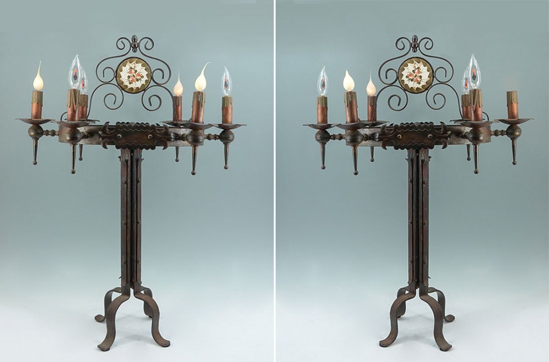 PAIR WROUGHT IRON GOTHIC REVIVAL TABLE LAMPS: PAIR WROUGHT IRON GOTHIC REVIVAL TABLE LAMPS: Wrought iron scroll finial with inset floral design porcelain medallions, 6 electric light fixtures, straight bodies with "buttons", shaped feet. Measures
