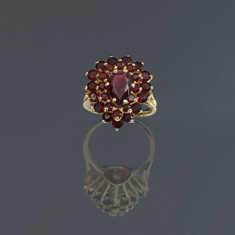 14K GARNET RING: 14K GARNET RING: 14K yellow gold ring contains 28 pear and round mixed cut garnets. Weight: 6.00 Ct. Approx. The garnets are prong set. Weight: 7.1 grams. Size: 7