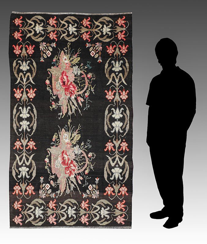 30-50 YEAR OLD ROMANIAN HAND WOVEN FLATWEAVE WOOL RUG: APPROX. 30-50 YEAR OLD ROMANIAN HAND WOVEN FLATWEAVE WOOL RUG 2' x 7': This interesting flatweave rug has a design that includes two European style baskets of flowers side by side on a brown/black gro