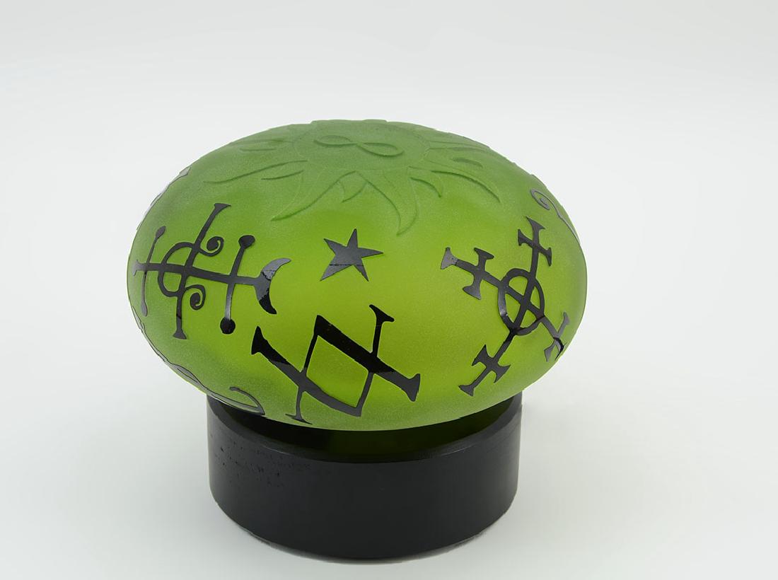 DUNCAN MCCLELLAN ART GLASS SCULPTURE: DUNCAN MCCLELLAN ART GLASS SCULPTURE: Early piece from Duncan, green frosted glass with carved sun with infinity symbol, other black enhanced mystic symbols on sides. Signed on base Duncan McClellan #