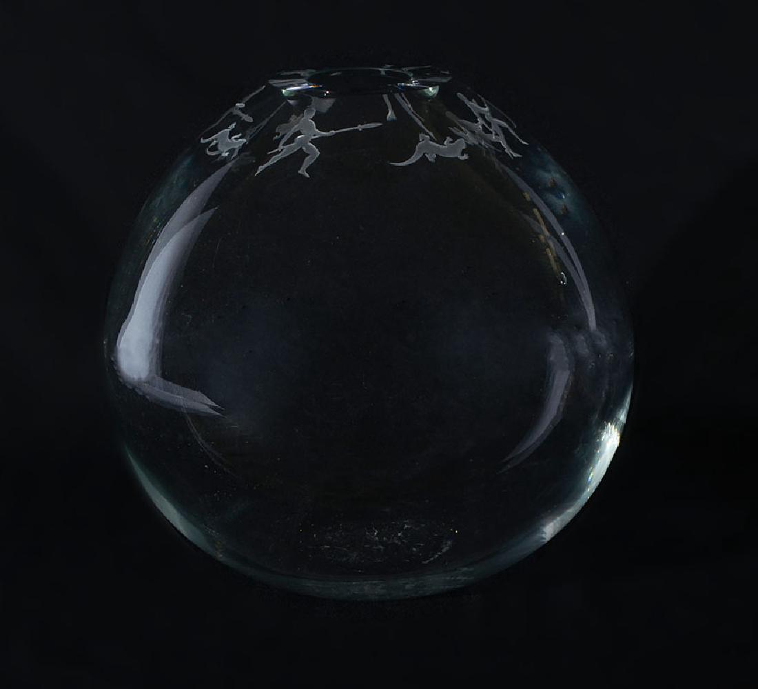 DUNCAN MCCLELLAN ART GLASS VASE: DUNCAN MCCLELLAN ART GLASS VASE: Clear glass globe form vase, rim with repeating carved pattern of alternating man with spear and figural lizard design. Signed on base and numbered 1/25. Overall measu