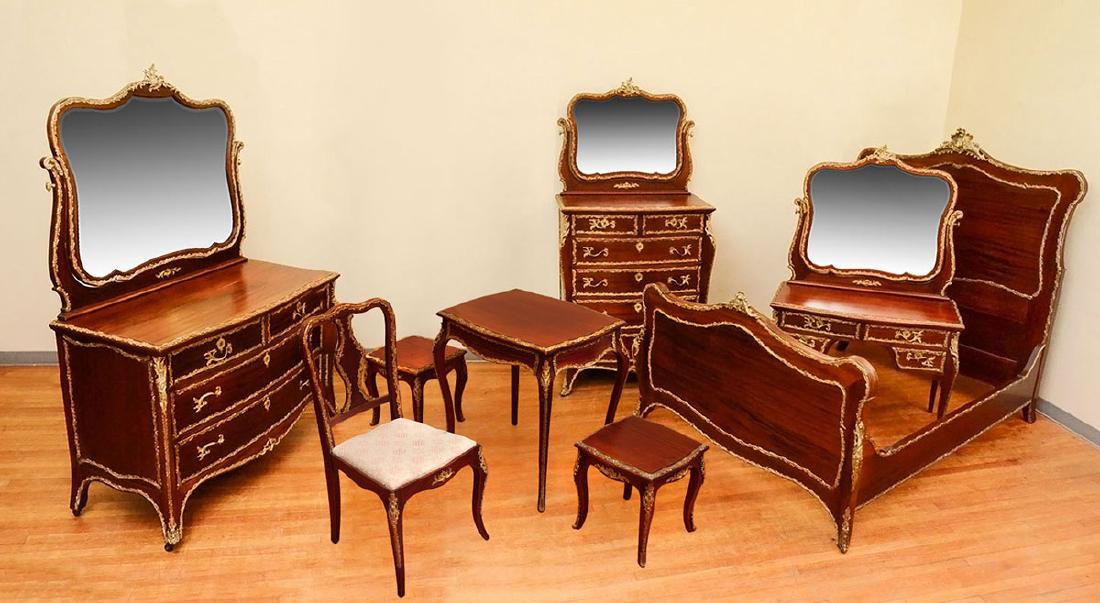 FRENCH MAHOGANY GILT METAL MOUNTED BEDROOM SUITE: FRENCH MAHOGANY GILT METAL MOUNTED BEDROOM SUITE: 8 piece bedroom suite with rococo style foliate accents on each piece to include 1) Bed, headboard measures 69'' h. x 59 1/2'' x 3 3/4''; foot board 3