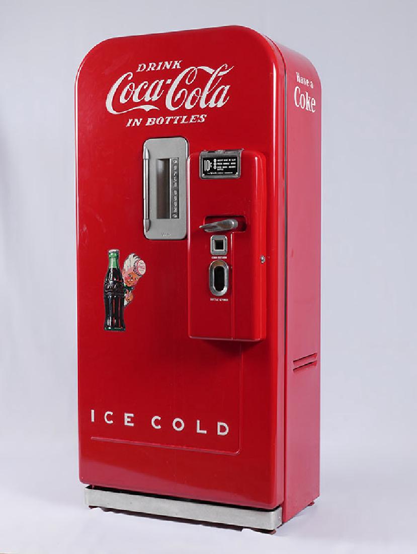 NICELY RESTORED COCA COLA VENDO 39 MACHINE: NICELY RESTORED COCA COLA VENDO 39 MACHINE: Circa 1950's, serial number E 312 55743. Vibrant red with embossed Coca Cola, 10 cent machine, vends 39 bottles. Overall measures 59'' h. x 27'' x 20 1/2''.