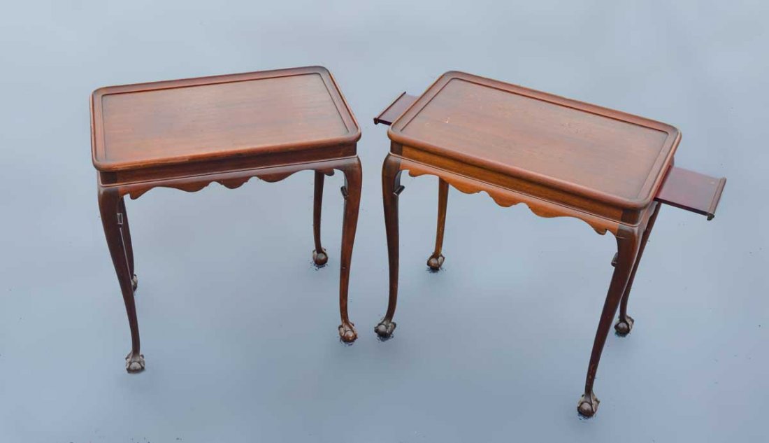 PAIR QUEEN ANNE MAHOGANY TEA TABLES: PAIR QUEEN ANNE MAHOGANY TEA TABLES: Matched pair of Queen Anne style tea tables with candle slide at wither end, shaped skirt, legs ending in claw and ball feet. 26" h. x 24 3/4" x 15 1/4".