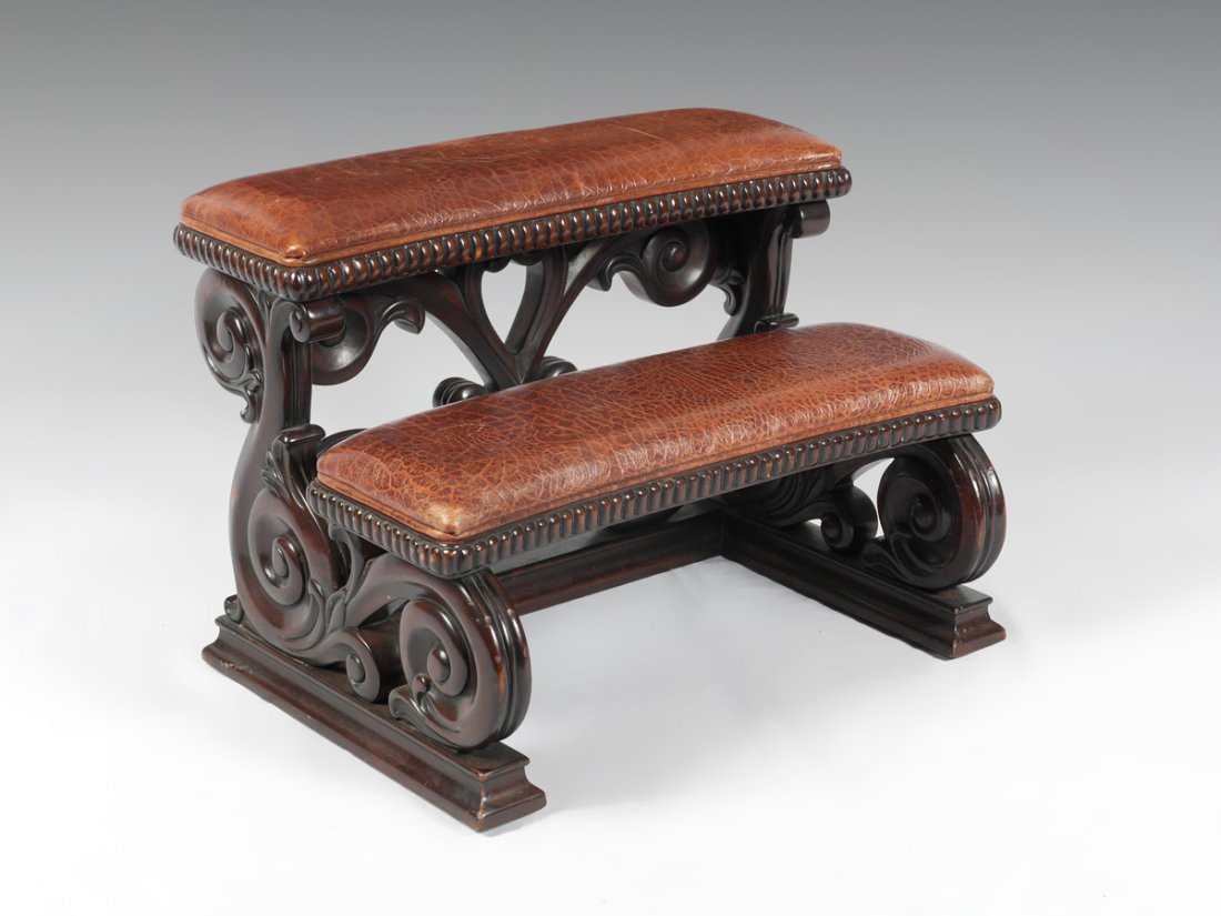 CARVED MAHOGANY REGENCY STYLE BED STEP: CARVED MAHOGANY REGENCY STYLE BED STEP: Openwork scroll carved sides and back support, padded brown faux alligator steps, later 20th century production. Measures 18" h. x 24" x 17 1/2".