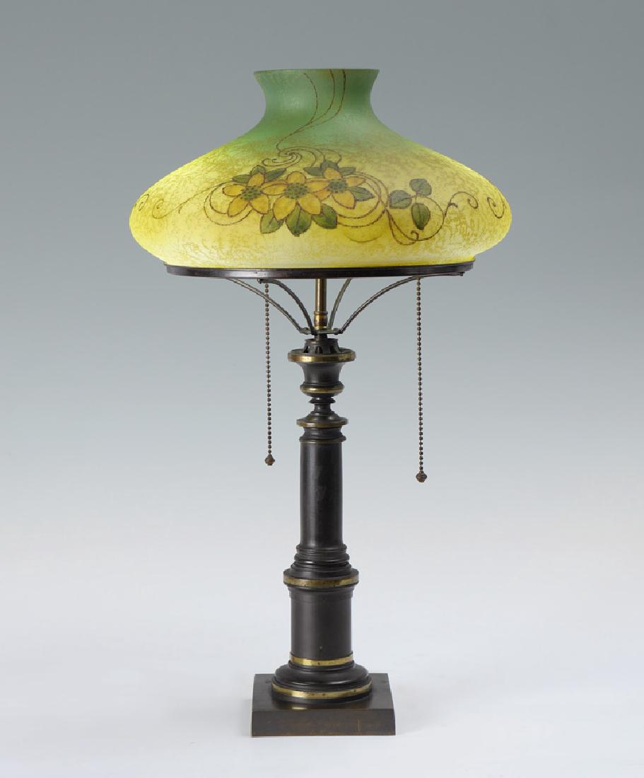 HANDEL SIGNED REVERSE PAINTED SHADE LAMP: HANDEL SIGNED REVERSE PAINTED SHADE LAMP: Weighted cast mixed metal base, unmarked, 2 socket fixture, ring with spider supports, 17 3/4'' h. x 10 1/4''. Reverse painted chipped ice bell form shade wit
