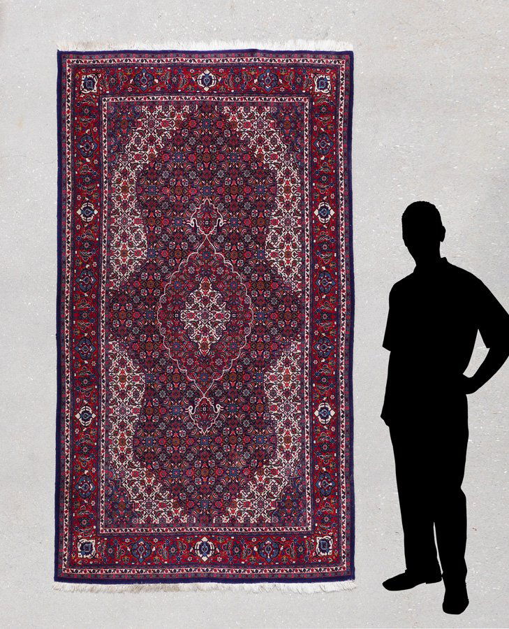 PAKISTANI PERSIAN HK WOOL RUG, 4'3" X 7'5": APPROX 20-45 YR OLD PAKISTANI PERSIAN HAND KNOTTED WOOL RUG, 4'3" X 7'5": This attractive rug has a fine weave that allowed the makers to create a very detailed, intricate pattern. The large red groun