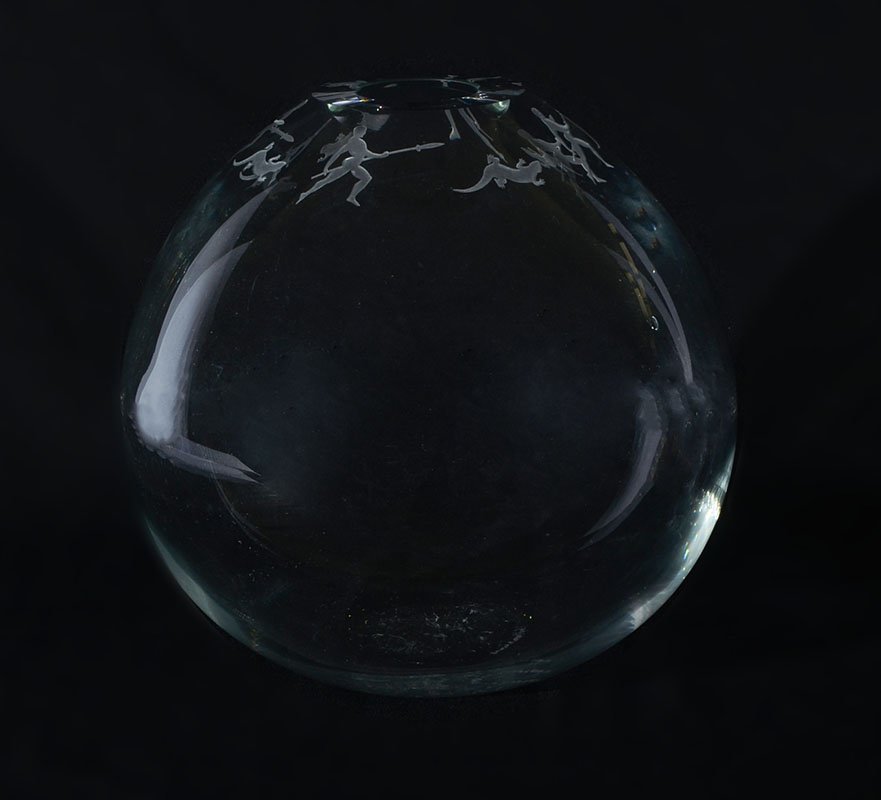 DUNCAN MCCLELLAN ART GLASS VASE: DUNCAN MCCLELLAN ART GLASS VASE: Clear glass globe form vase, rim with repeating carved pattern of alternating man with spear and figural lizard design. Signed on base and numbered 1/25. Overall measu