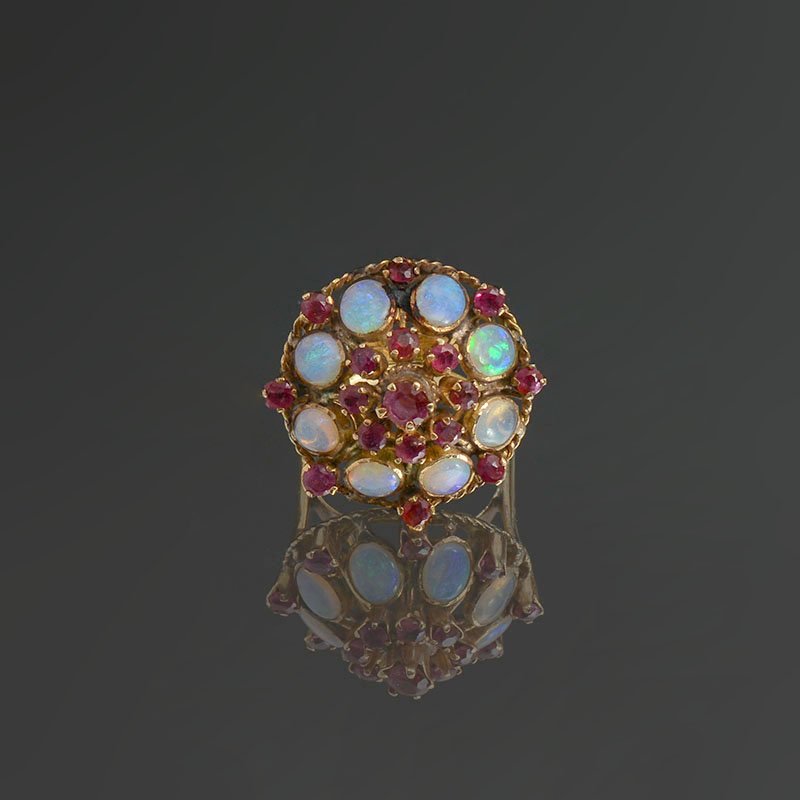 VINTAGE OPAL & RUBY ENGAGEMENT RING IN THE PRINCES: VINTAGE OPAL & RUBY ENGAGEMENT HAREM RING: This ring is set with 8 fiery opals that display flashes of pink, blue, green and purple. 8 rubies occupy the bottom tier of this ring, then the opals, then