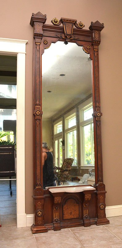HIGH VICTORIAN WALNUT PIER MIRROR: HIGH VICTORIAN WALNUT PIER MIRROR: Center crest with carved gilt accents, frame with applied carved and burl veneer decoration, lower shaped marble shelf. 98" h. x 35 1/2" x 10 1/2".