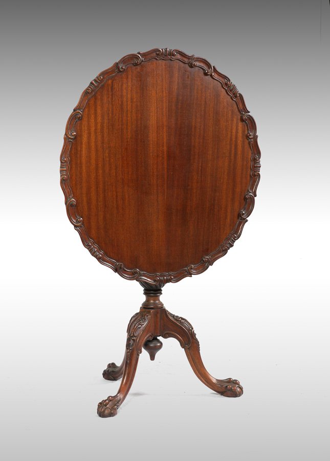 PIE CRUST TILT TOP TABLE: PIE CRUST TILT TOP TABLE: Early 20th century mahogany tilt top table, carved pie crust trim, turned columns, 3 carved splayed legs ending in claw and ball feet, 30" h. x 28 3/4".