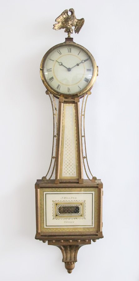SIMON WILLARD PATENT REVERSE PAINTED BANJO CLOCK: SIMON WILLARD PATENT REVERSE PAINTED BANJO CLOCK: Gilt metal eagle finial, case with mahogany sides, tapered reverse painted body with brass side ornaments, reverse painted center throat and tablet, m