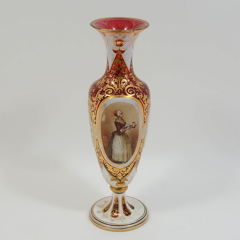 BOHEMIAN CRANBERRY GLASS PORTRAIT VASE: BOHEMIAN CRANBERRY GLASS PORTRAIT VASE: Flared rim, cranberry glass body with white accent panels. Center ring of panel with portrait of a servant and 3 floral motif medallions, white over cranberry f