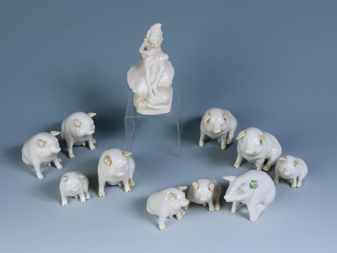 11 PIECE BELLEEK PIGS & LEPRECHAUN FIGURES: 11 PIECE BELLEEK PIGS & ELF PORCELAIN FIGURES: 11 pieces total to include 6 pigs (3'' h.), 4 pigs (2'' h.), leprechaun seated on toadstool (4 3/4'' h.)