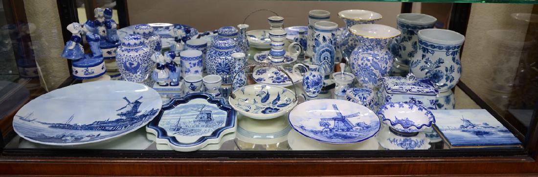 ESTATE COLLECTION OF DELFT BLUE ITEMS: ESTATE COLLECTION OF DELFT BLUE ITEMS: An assembled collection of approx. 21 contemporary and vintage Delft blue to include charger, plates, ginger jars, bowls, cups, vase, covered box, figures and mo