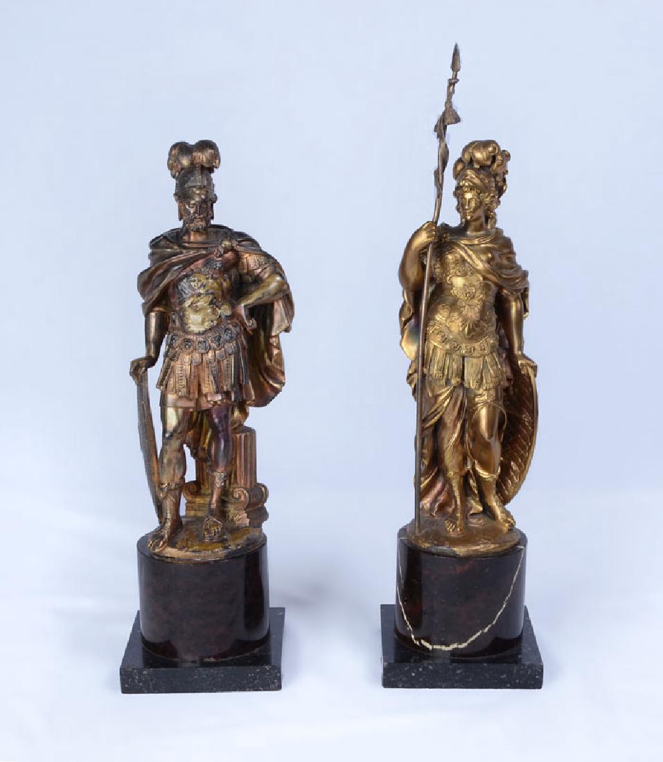 PAIR FRENCH BRONZE DORE ROMAN SOLDIER FIGURES: PAIR FRENCH BRONZE DORE ROMAN SOLDIER FIGURES: 2 figures, one man leaning on a shield, the other a woman holding a staff, both on marble pedestal bases. No visible signature or foundry mark, the woman
