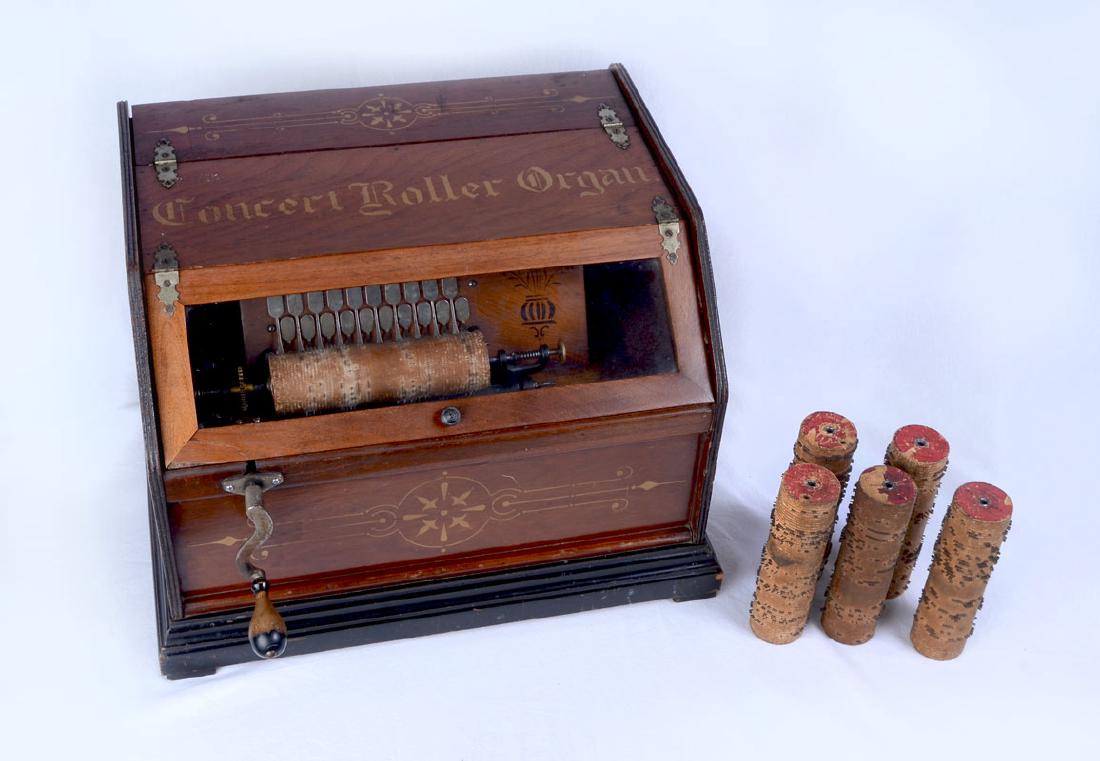 CONCERT ROLLER ORGAN WITH EXTRA COBS: CONCERT ROLLER ORGAN WITH EXTRA COBS: Late 19th century, case with stenciled designs on sides and ''Concert Roller Organ'' on top. Turning crank operates bellows and paddles according to cob roll, sol