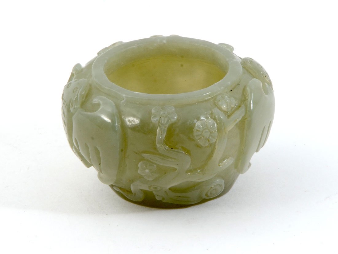 MINIATURE CARVED JADE BRUSH WASHER: MINIATURE CARVED JADE BRUSH WASHER: Carved celadon jade or similar stone brush washer with bats and flowering trees design, 1 1/4'' h. x 2'' dia.