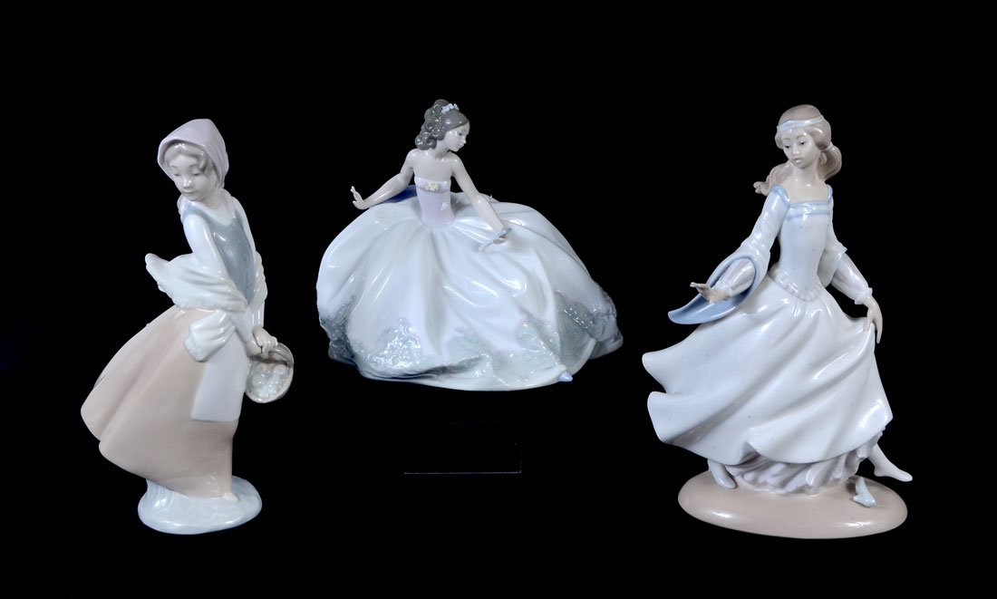 3 LLADRO AND NAO PORCELAIN FIGURINES: 3 LLADRO AND NAO PORCELAIN FIGURINES: 3 pieces total to include 1) Lladro At the Ball, issued 1992, 6'' h. 2) Lladro Cinderella, issued 1972, retired 1978, 9 3/4'' h. 3) Nao maiden holding basket, 9 1