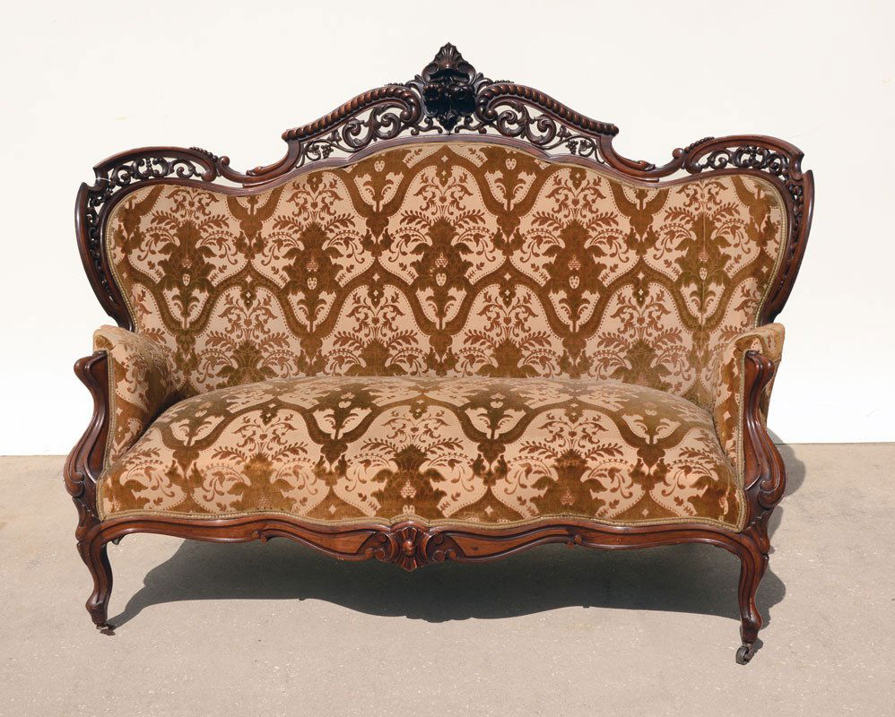 MEEKS STANTON HALL CARVED SOFA: MEEKS STANTON HALL CARVED SOFA: Foliate scroll reticulated pierced carved top rail and sides, center foliate crest, shaped hand holds, carved and shaped skirt, front legs ending in castors. Raised vel